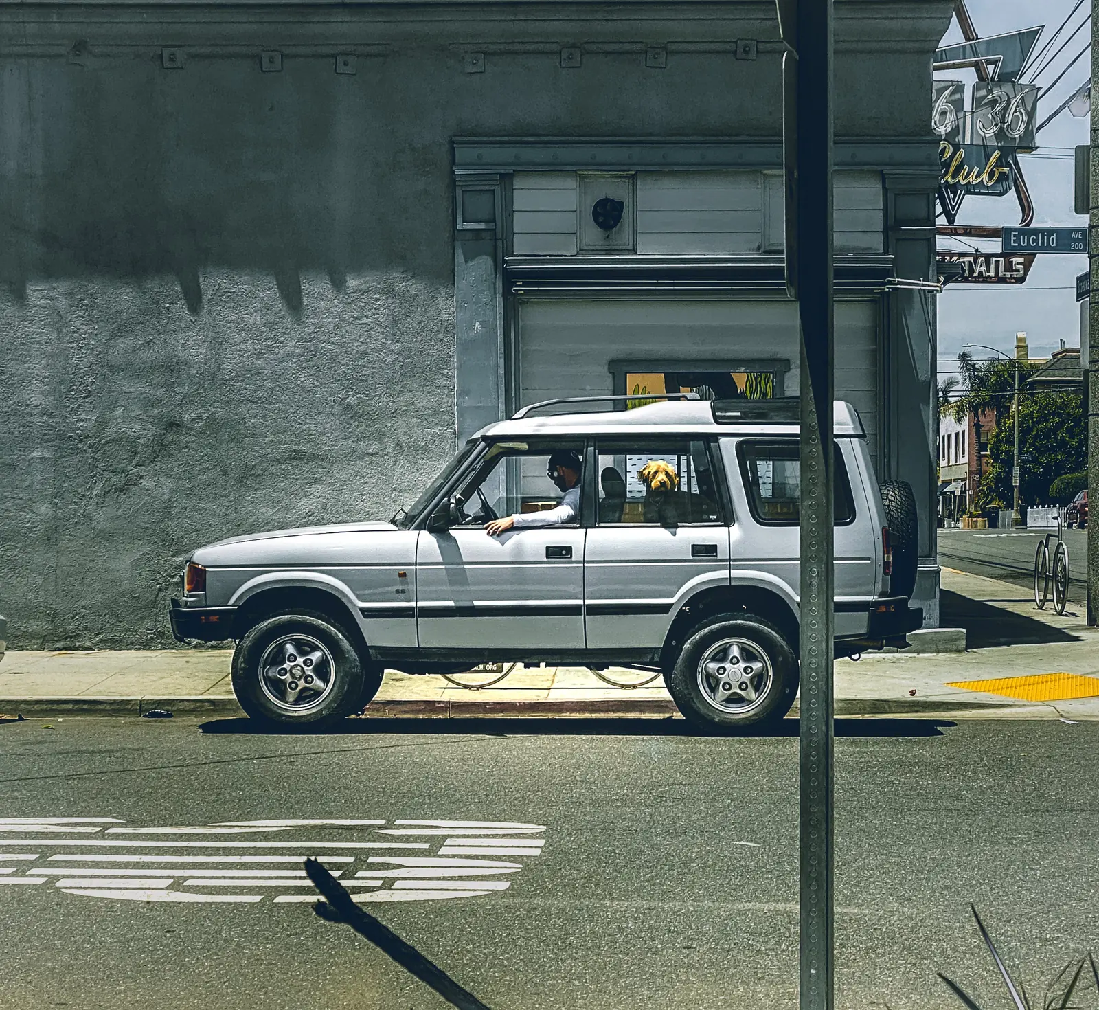 Vintage Land Rover Discovery parked outside Club Tails on Euclid Avenue, Las Vegas — the kind of long-haul vehicle that ages with the work